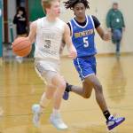 KEITH THORPE/PENINSULA DAILY NEWS Port Angeles Gus Halberg, left, is pursued by Bremertons Enoch Taylor on Thursday at Port Angeles High School.