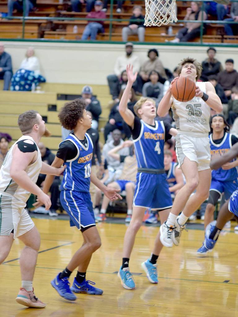 KEITH THORPE/PENINSULA DAILY NEWS Port Angeles Parker Nickerson, right, rises to the occassion as teammate Ezra Townsend, left, and Bremertons Jalen Davis and Dillon McKay look on during Thursdays game in Port Angeles.