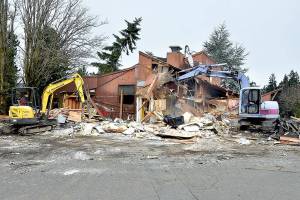 A pair of excavators demolish the former Bushwhacker Restaurant in Port Angeles on Saturday, clearing the space for a future Popeyes Louisiana Kitchen. (Keith Thorpe/Peninsula Daily News)