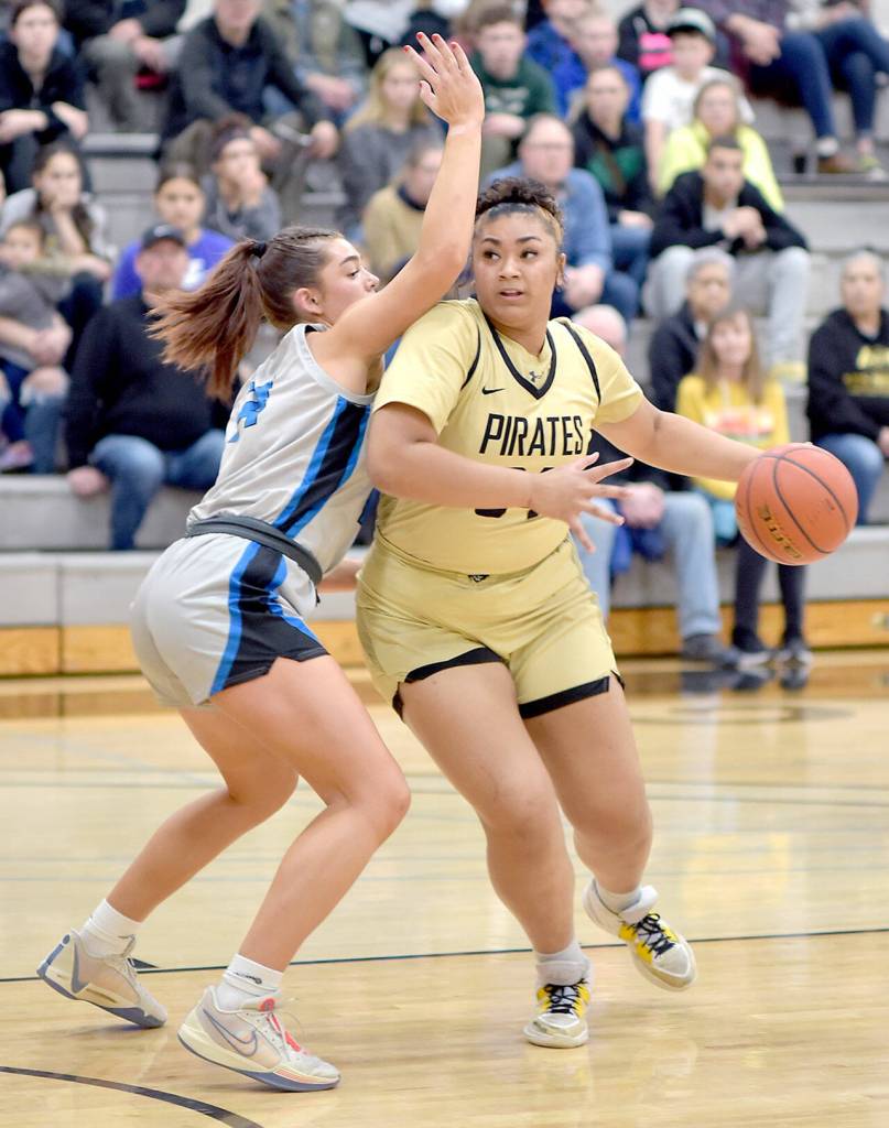 KEITH THORPE/PENINSULA DAILY NEWS 
Peninsula's Jelissa Julmist, right, works around the defense of Edmonds' Natalie Brown on Saturday in Port Angeles.