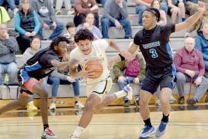 KEITH THORPE/PENINSULA DAILY NEWS 
Peninsula's Javon Ervin, center, pushes through the defense of Edmonds' Kalifa Ceesay, left, and Solomon Barnes on Saturday afternoon at Peninsula College.