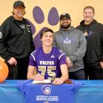 Sequims Jack Henninger signs a letter of intent to play football at the University of Mary (North Dakota). The all-Olympic League kicker plans to study occupational therapy and kick for the Marauders football squad. Behind him are, from left, soccer coach David Breckenridge, football special teams coach Cody Buckmaster and football head coach Erik Wiker. (Michael Dashiell/Olympic Peninsula News Group)
