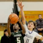 Sequims Charlie Grider (11) defends the rim against Evergreens Mohamed Abdi (5) in Tuesdays bidistrict basketball playoff game in Sequim. (Michael Dashiell/Olympic Peninsula News Group)