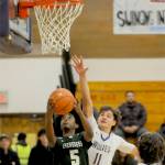 Sequims Charlie Grider (11) defends the rim against Evergreens Mohamed Abdi (5) in Tuesdays bidistrict basketball playoff game in Sequim. (Michael Dashiell/Olympic Peninsula News Group)