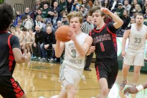Port Angeles Gus Halberg drives the ball against Sammamish on Tuesday night in Port Angeles. The Roughriders lost the district playoff game 65-57, but they are still alive in the postseason and play again at home tonight at 6 p.m. against Steilacoom. (Dave Logan/for Peninsula Daily News)
