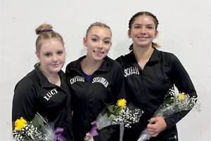 From left, Sequims Lucy Spelker and Susannah Sharp and Port Angeles Scarlett Sullivan all qualified for the state gymnastics meet Friday. (Courtesy photo)