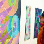 (Northwind Art Richard Coletta) 
Richard Coletta of Port Townsend admires Caryl Fallert-Gentry's quilt titled "Electric Snails," part of the "Burst of Color" exhibit at Jeanette Best Gallery.