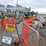 A paving crew from Lakeside Industries replaces pavement on the Waterfront Trail and the entrance to the Port Angeles City Pier parking lot on Wednesday as part of a project to improve sidewalks and storm water drainage around the site. The project is expected to be substantially completed and the parking lot reopened by mid-March. (Keith Thorpe/Peninsula Daily News)