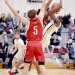 Peninsulas Ese Onakpoma, right, fades back for the jumper surrounded by Skagit Valleys Jacob Bilodeau, front, and Sylas Williams on Wednesday night at Peninsula College. (Keith Thorpe/Peninsula Daily News)