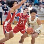 Peninsulas Jason Ervin, right, is held off by Skagit Valleys Sylas Williams, left, and Connor Drinkwine on Wednesday night in Port Angeles. (Keith Thorpe/Peninsula Daily News)