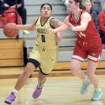 Peninsulas Ciera Agasiva, left, slips around the defense of Skagit Valleys Jenae Rhoads on Wednesday at Peninsula College. (Keith Thorpe/Peninsula Daily News)