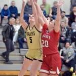 Peninsulas Alexa Mackey, left, competes for a rebound with Skagit Valleys McKenna Wichers, right, and Jenae Rhoads on Wednesday in Port Angeles. (Keith Thorpe/Peninsula Daily News)
