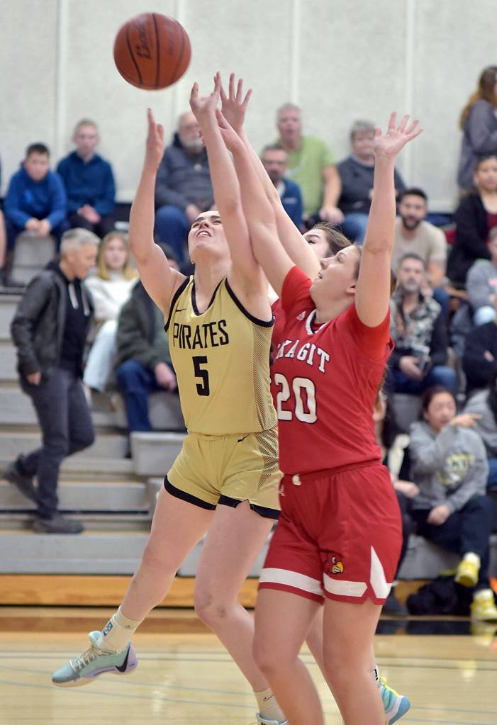 Peninsulas Alexa Mackey, left, competes for a rebound with Skagit Valleys McKenna Wichers, right, and Jenae Rhoads on Wednesday in Port Angeles. (Keith Thorpe/Peninsula Daily News)