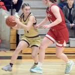 Peninsulas Talia Marini, left, works in from the corner around Skagit Valleys Jenae Rhoads on Wednesday evening in Port Angeles. (Keith Thorpe/Peninsula Daily News)