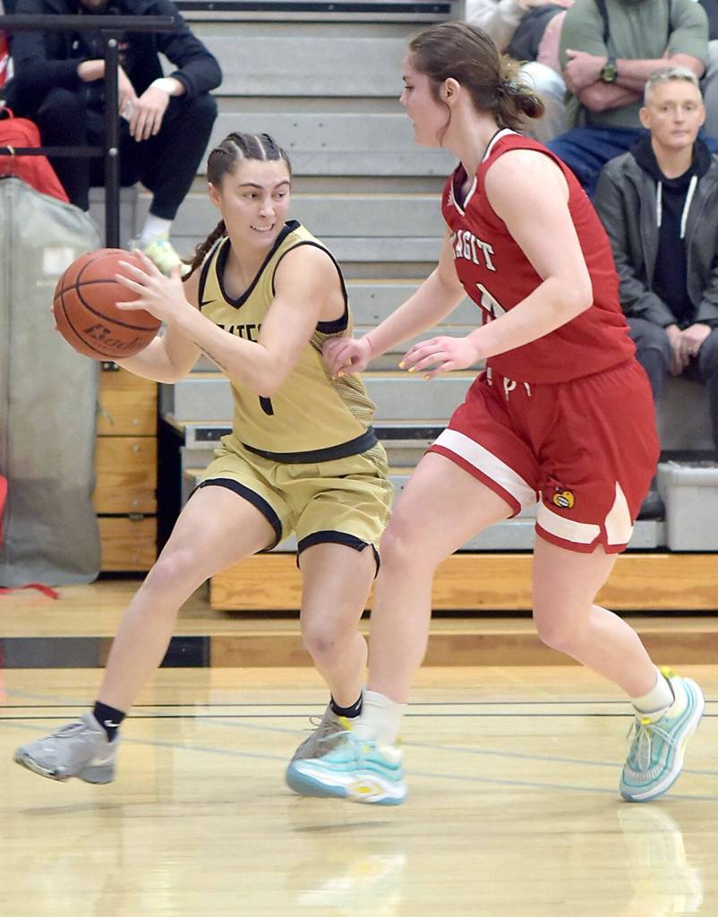 Peninsulas Talia Marini, left, works in from the corner around Skagit Valleys Jenae Rhoads on Wednesday evening in Port Angeles. (Keith Thorpe/Peninsula Daily News)