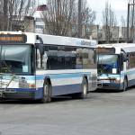 A pair of Clallam Transit buses sit at The Gateway Transit Center in Port Angeles in preparation for their fixed-route runs on Thursday. (Keith Thorpe/Peninsula Daily News)