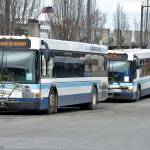 A pair of Clallam Transit buses sit at The Gateway Transit Center in Port Angeles in preparation for their fixed-route runs on Thursday. (Keith Thorpe/Peninsula Daily News)