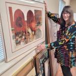 Shipley Center Program Director Reba Renner, program director at the Shipley Center, sorts through more than 80 works of art that will be sold at the centers art soiree Thursday evening.