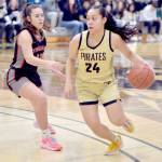 KEITH THORPE/PENINSULA DAILY NEWS Peninsulas Shania Moananu, right, crosses the three-point line as Everetts Ashlynd Hunt tries to keep up on Saturday afternoon at Peninsula College.
