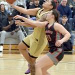 KEITH THORPE/PENINSULA DAILY NEWS Peninsulas Ciera Agasiva, left, aims for the rim pursued by Everetts Jada Andresen on Saturday in Port Angeles.