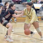 KEITH THORPE/PENINSULA DAILY NEWS Peninsulas Jelissa Julmist, right, steps into the lane defended by Everetts Ella Curry on Saturday afternoon in Port Angeles.