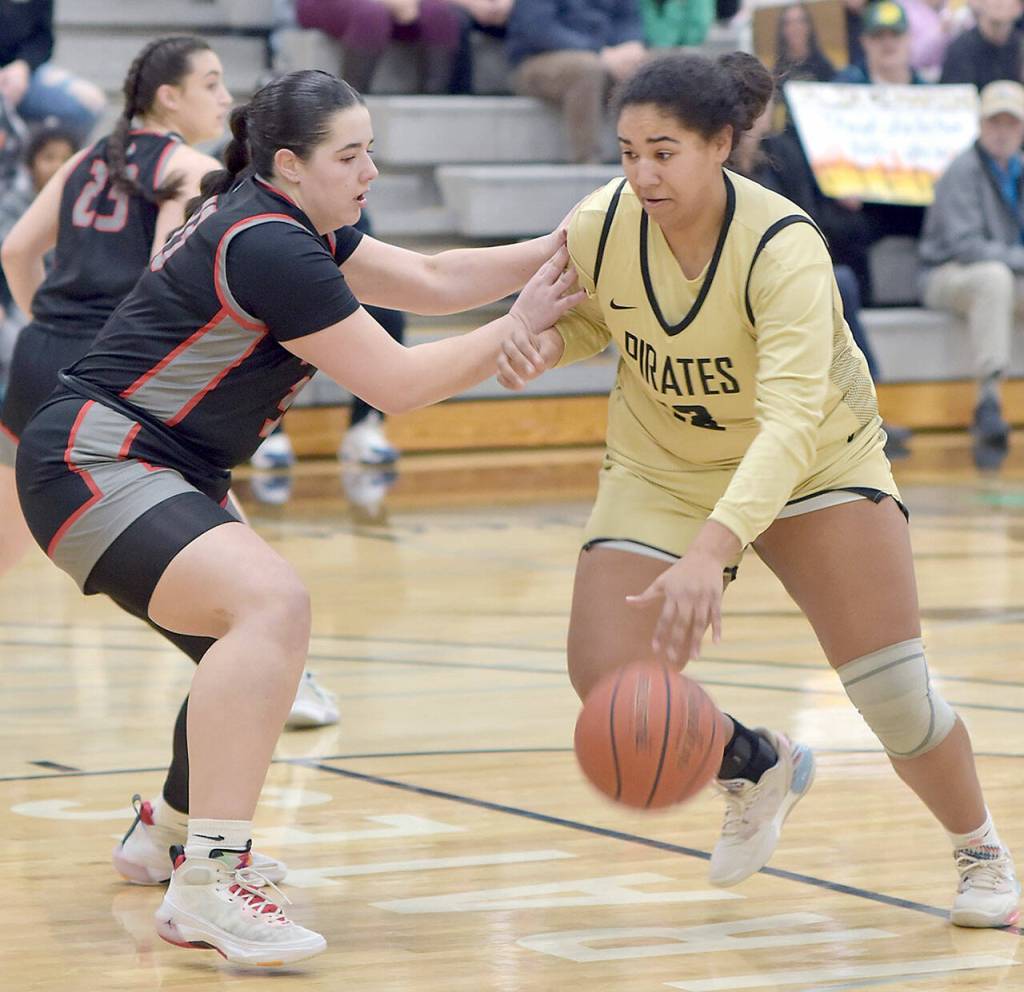 KEITH THORPE/PENINSULA DAILY NEWS Peninsulas Jelissa Julmist, right, steps into the lane defended by Everetts Ella Curry on Saturday afternoon in Port Angeles.