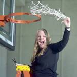 Peninsula Pirates head coach Ali Crumb swings a freshly cut net on Saturday in jubilation for winning the NWAC North Division championship, sending her team to the playoffs. As icing on the cake, Peninsula beat Everett 86-51 earlier in the evening. (Keith Thorpe/Peninsula Daily News)