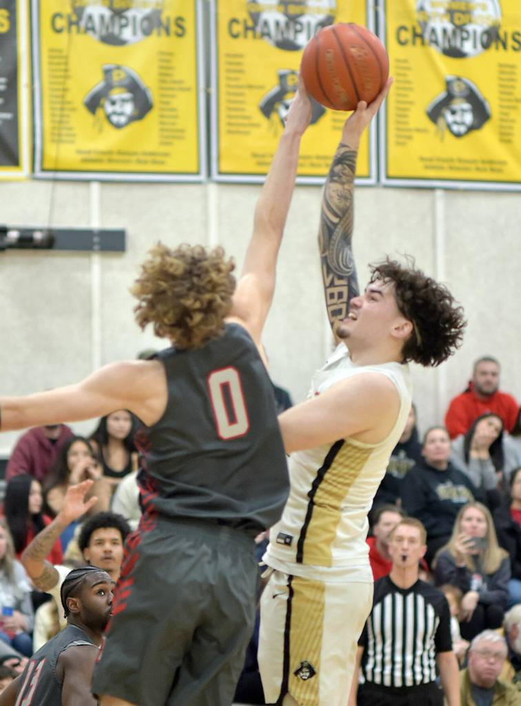 Peninsulas Aiden Omstead, right, puts the ball up over Everetts Hayden Conaxis on Saturday evening in Port Angeles. (Keith Thorpe/Peninsula Daily News)