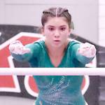 Scarlett Sullivan of Port Angeles competes in the bars at the state gymnastics meet at Sammamish High School. (Kevin Hanson/Enumclaw Courier-Herald)