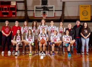 The Neah Bay girls basketball team is looking to win back-to-back state championships at the state tournament this weekend. From left, back row, is head coach Cherish Moss, assistant Cierra Knaus, Wiinuk Martin, Angel Halttunen, Ezrah Ray, Amber Swan, Ryana Moss, assistants Gina McCauley and Tony McCauley and manager Brooklynn Johnson. From left, sitting, are Brianna McGimpsey, Danica Halttunen, Qwaapeys Greene, Caylee Moss and Cerise Moss.