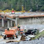 Work progresses on the road deck of the main over-water spans at the site of a new U.S. Highway 101 bridge over the Elwha River southwest of Port Angeles on Thursday. The bridge will replace an older nearby span that was determined to have structurally-deficient pier footings. The $36 million project is expected to be completed in December. (KEITH THORPE/PENINSULA DAILY NEWS)