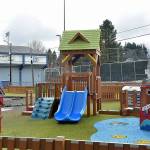 Unburned portions of the Port Angeles Dream Playground at Erickson Playfield stand on Thursday next to an area that was burned in an arson fire in December. (Keith Thorpe/Peninsula Daily News)