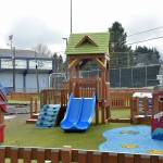 Unburned portions of the Port Angeles Dream Playground at Erickson Playfield stand on Thursday next to an area that was burned in an arson fire in December. (Keith Thorpe/Peninsula Daily News)