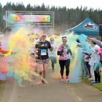 Participants in the Sequim Sunshine Festival 5K Sun Fun Color Run navigate through a gauntlet of tempera paint on Saturday at the Albert Haller Play Fields at Carrie Blake Park. The two-day festival, hosted by the City of Sequim, also featured food, music, youth activities, a craft fair and a drone show. (Keith Thorpe/Peninsula Daily News)