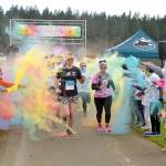 Participants in the Sequim Sunshine Festival 5K Sun Fun Color Run navigate through a gauntlet of tempera paint on Saturday at the Albert Haller Play Fields at Carrie Blake Park. The two-day festival, hosted by the City of Sequim, also featured food, music, youth activities, a craft fair and a drone show. (Keith Thorpe/Peninsula Daily News)