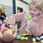Skylar Sutherland, 5, of Port Angeles uses a toy stethoscope during a pretend examination of a doll at an information table set up by Olympic Medical Centers New Family Services and Pediatrics departments during Saturdays 35th annual Kids Fest at Vern Burton Community Center in Port Angeles. The event, hosted by Port Angeles Kiwanis, featured a variety of displays and information tables showcasing family and childrens services. Kids Fest also included numerous outdoor public safety displays organized by Clallam County Emergency Services. (Keith Thorpe/Peninsula Daily News)