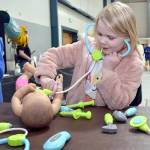 Skylar Sutherland, 5, of Port Angeles uses a toy stethoscope during a pretend examination of a doll at an information table set up by Olympic Medical Centers New Family Services and Pediatrics departments during Saturdays 35th annual Kids Fest at Vern Burton Community Center in Port Angeles. The event, hosted by Port Angeles Kiwanis, featured a variety of displays and information tables showcasing family and childrens services. Kids Fest also included numerous outdoor public safety displays organized by Clallam County Emergency Services. (Keith Thorpe/Peninsula Daily News)