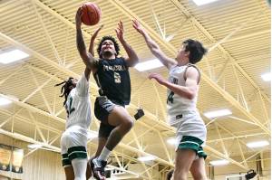 Peninsula Colleges Javon Ervin drives to the hoop between Shoreline defenders Jordan Smalls, left, and Derek Nordale, right. Ervin scored 27 as Peninsula won 83-70 to advance to the NWAC Tournament. (Jay Cline/Peninsula College)