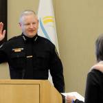 Mike Hill takes his oath of office on Friday from acting city clerk Heather Robley to become the City of Sequims new police chief. (Matthew Nash/Olympic Peninsula News Group)