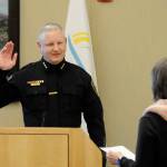 Mike Hill takes his oath of office on Friday from acting city clerk Heather Robley to become the City of Sequims new police chief. (Matthew Nash/Olympic Peninsula News Group)