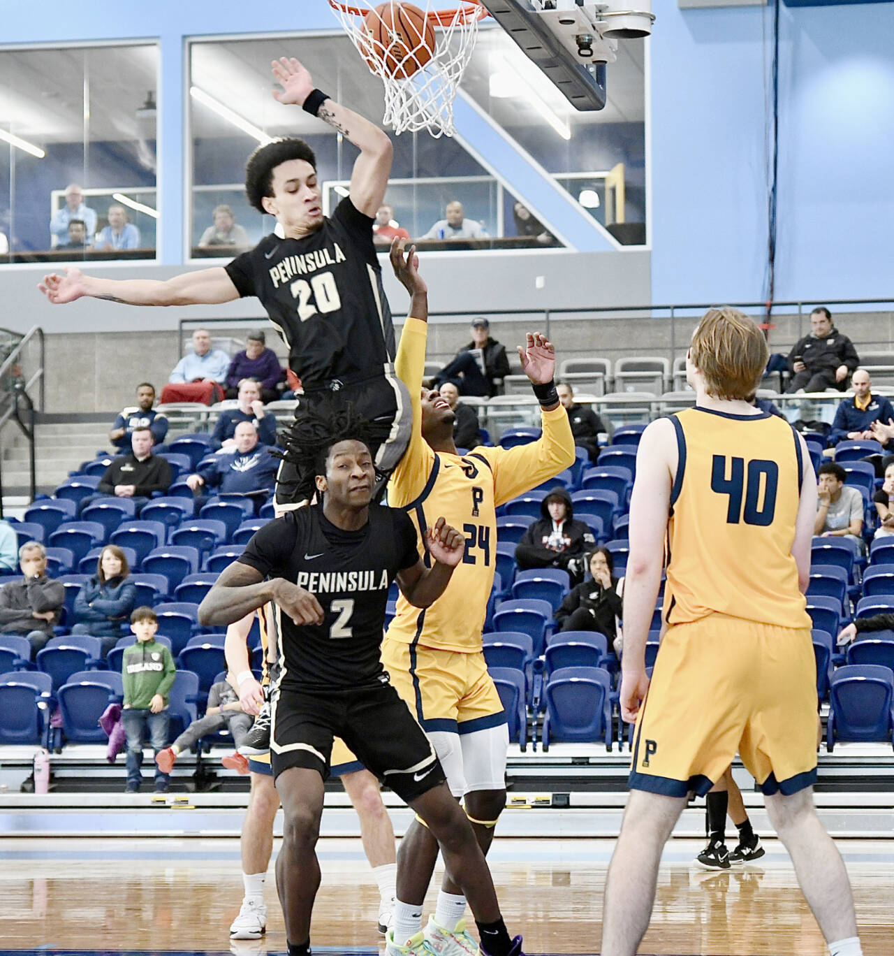 Peninsula Colleges DeShawn Rushmeyer (20) and Ese Onakpoma (2) battle for a rebound with Portlands Nydir Hodges (24) and Josh Lincoln (40) in the opening round of the NWAC tournament in Pasco on Wednesday. (Jay Cline/Peninsula College)