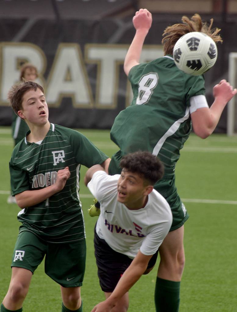 Port Angeles Jacob Weaver, top, takes the header over the top of East Jeffersons Aimando Sanchez, front, and teammate Kanyon Anderson on Saturday afternoon in Port Angeles. (Keith Thorpe/Peninsula Daily News)