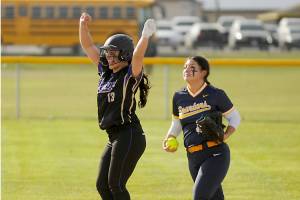 Sequim's Taylee Rome (13) celebrates a double as Forks' Lizzy Soto brings the ball into the infield Tuesday in Sequim. (Michael Dashiell/Olympic Peninsula Sports Group)