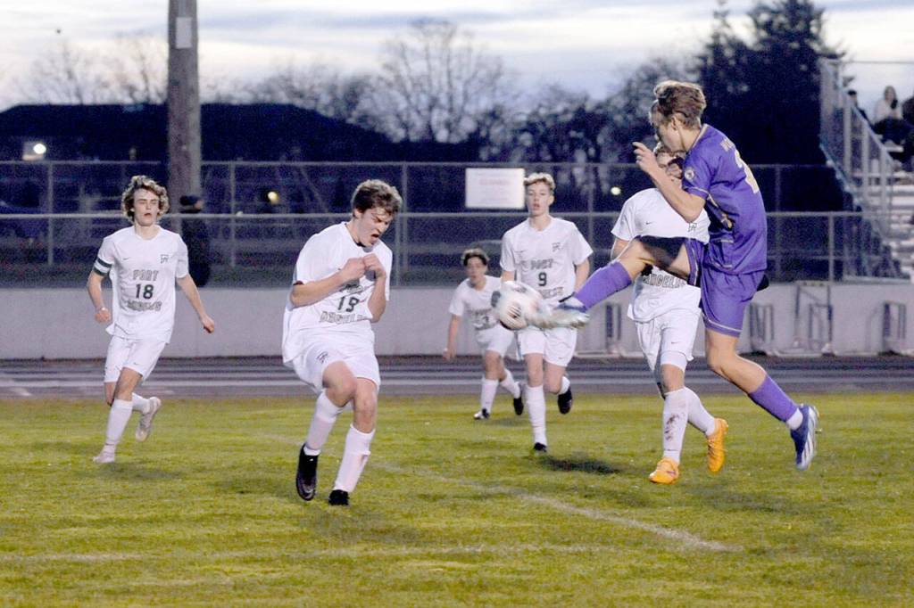 Matthew Nash/for Olympic Peninsula News Group Sequims Preston Kurtze puts a boot to the ball while surrounded by Port Angeles defenders Grant Butterworth, Jackson Wyall, Myles Close, Aurelio Wilson-Rojero and Caleb Lagrange (obscured) during the Wolves 4-2 win Thursday night.