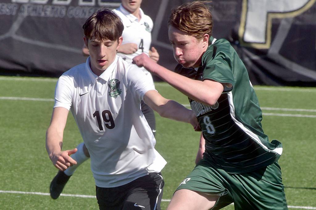 KEITH THORPE/PENINSULA DAILY NEWS
Port Angeles' Jacob Weaver, right, dribbles past Klahowya's Elijah Body as Klahowya's Oliver Peterson follows behind on Saturday at Peninsula College.
