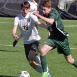 KEITH THORPE/PENINSULA DAILY NEWS Port Angeles Jacob Weaver, right, dribbles past Klahowyas Elijah Body as Klahowyas Oliver Peterson follows behind on Saturday at Peninsula College.