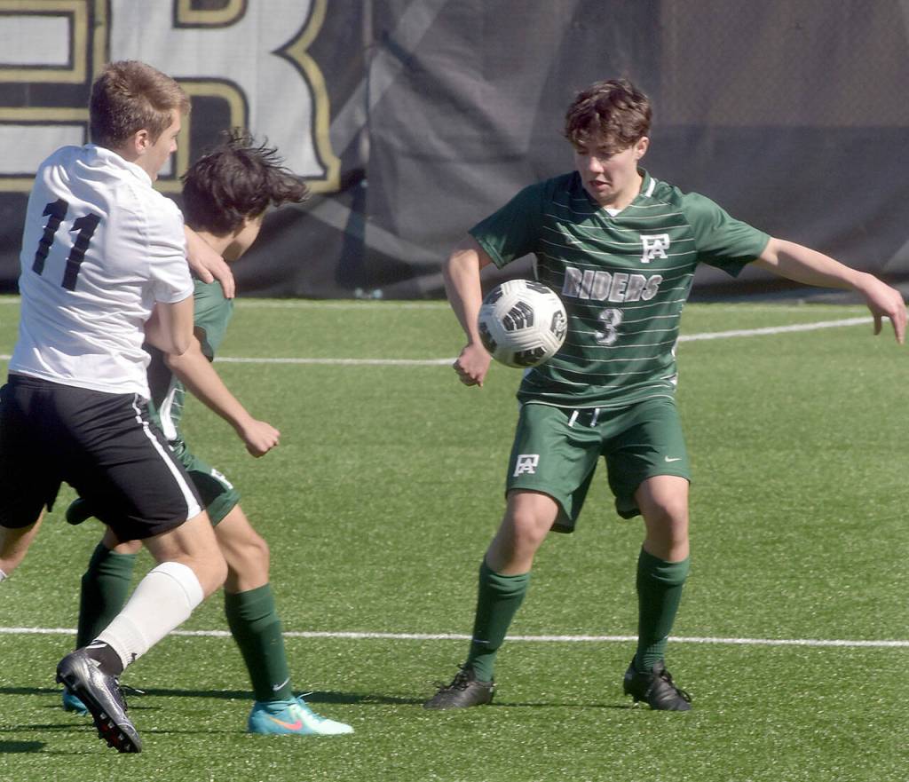 KEITH THORPE/PENINSULA DAILY NEWS Port Angeles Myles Close, right, settles a loose ball as Klahowyas Sage Bell, left, tries to get past Closes teammate Mason Spangler on Saturday in Port Angeles.