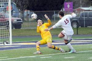 Lonnie Archibald/for Peninsula Daily News
Forks goalkeeeper Juan Terrones makes a close save on a shot attempt by Montesano's Felix Romero during the Spartans' 3-1 loss to the Bulldogs on Wednesday night.