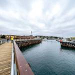 Matt Klontz with the Port of Port Townsend, in a yellow jacket, looks over the nearly completed south breakwater jetty at the entrance to Point Hudson Marina with Jacob Bates, an Orion employee, during a punch-list review on Wednesday. The jetty is expected to be finished next week. (Steve Mullensky/for Peninsula Daily News)