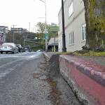 A tree that has grown out of its tree box and shattered a nearby curb and sidewalk in the 100 block of North Oak Street is among those targeted for removal and replacement in downtown Port Angeles. (Keith Thorpe/Peninsula Daily News)